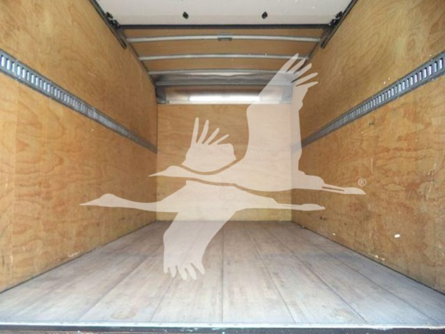 Isuzu NRR box truck cargo area showing wooden interior walls and empty cargo space.