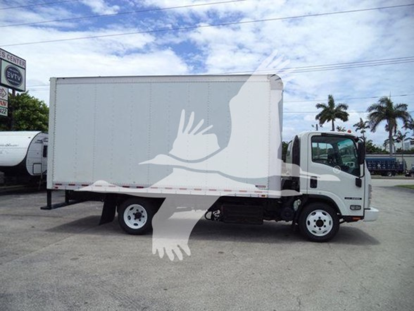 Isuzu NRR box truck side view showing cargo box and cab with white exterior.