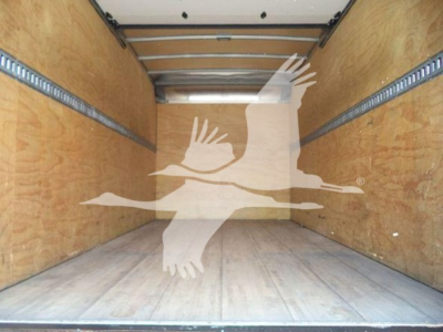 Isuzu NRR box truck cargo area showing wooden interior walls and empty cargo space.