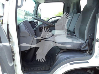 Isuzu NRR cab interior image showing driver's seat and front passenger seat with steering wheel and dashboard; light gray interior with rubber floor mats.