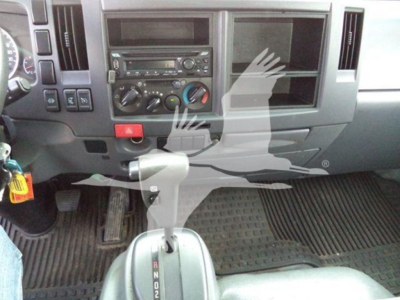 Isuzu NRR dashboard and center console with gear selector and climate controls in view.