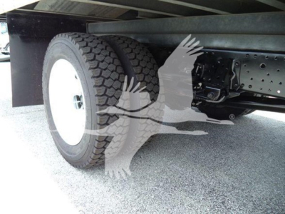 Isuzu NRR truck rear/underbody showing dual rear tires and frame with wheel, suspension, and leaf springs.