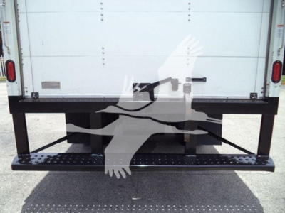 Isuzu NRR truck rear view showing a black steel lift/step bumper with steps, and white box van body in background.