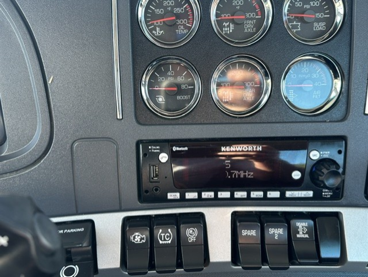 Kenworth T880 dash cluster and Kenwood stereo display with multiple gauges and switches visible.