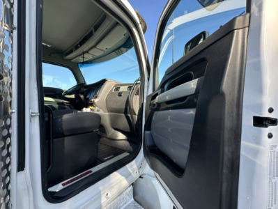 Kenworth T880 cab interior and open driver door showing dashboard and seating.