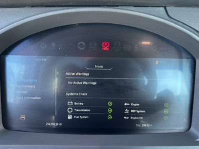 Kenworth T880 dash showing system checks on screen with various green OK icons and active warnings indicating battery, transmission, fuel system, engine.