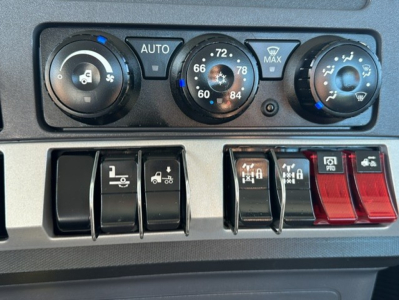 Dashboard controls with climate knobs and various switches; no legible part labels or VIN visible in image.