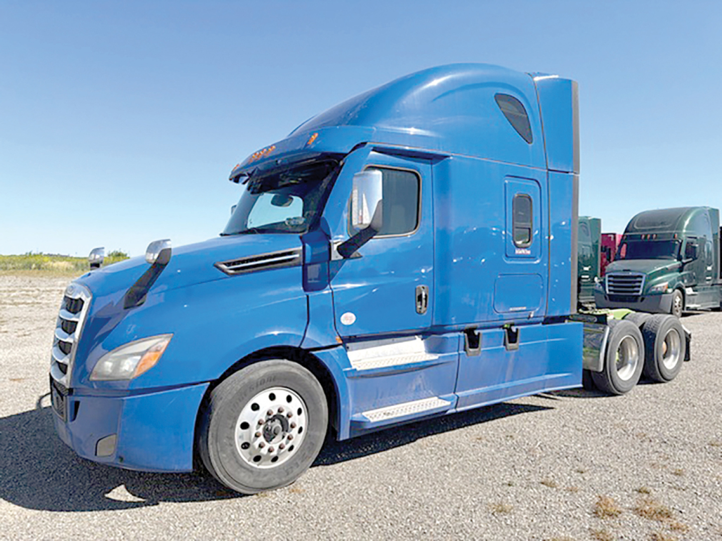 Blue Freightliner Cascadia126 conventional sleeper truck in a parking lot, front-right view, visible cab details and chassis.