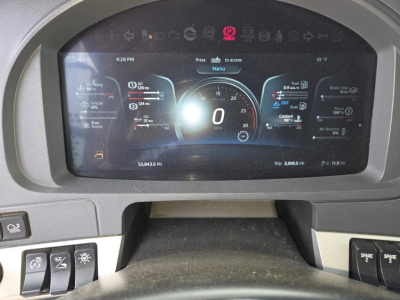 Kenworth W990 dashboard display showing digital gauges and vehicle information.