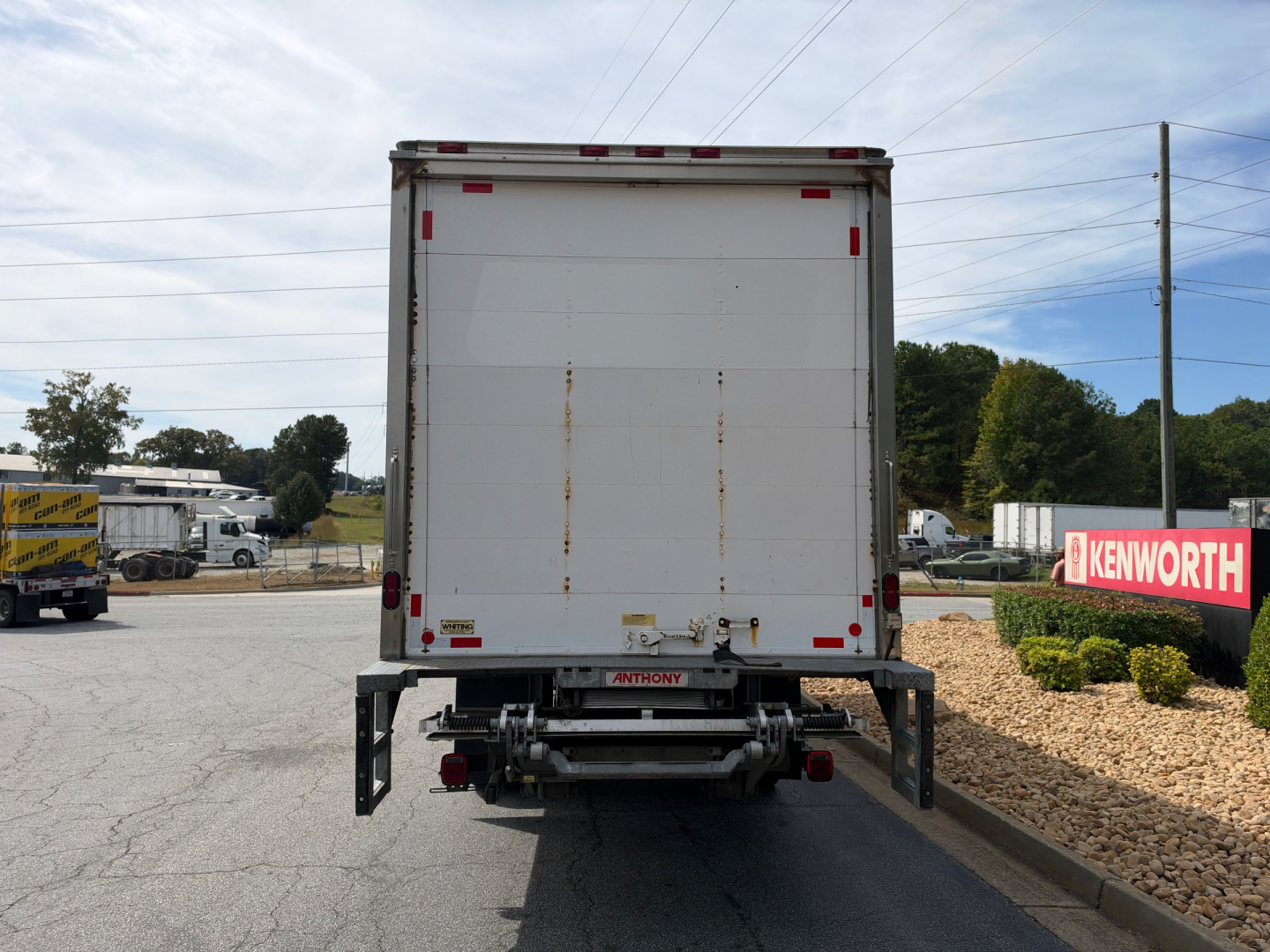 Rear view of a 2019 Hino 268A box truck showing the closed cargo area and bumper with hitch.