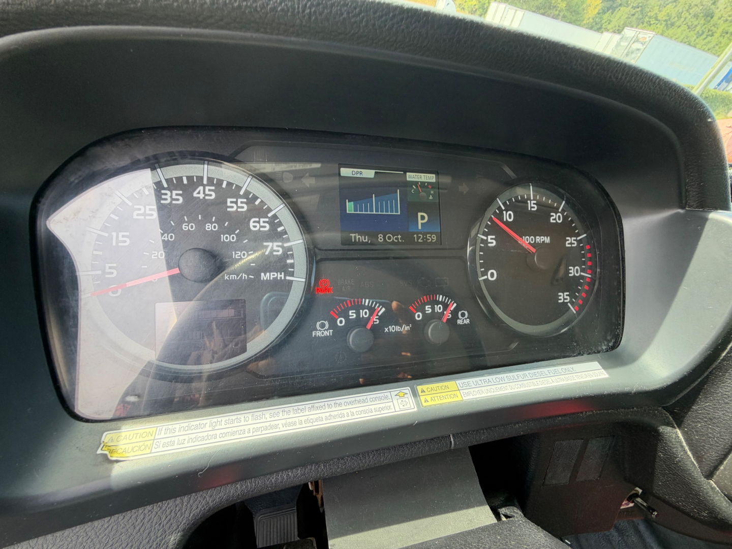 Dashboard of a 2019 Hino 268A showing speedometer, tachometer, and multifunction display with warning icons and gauges.