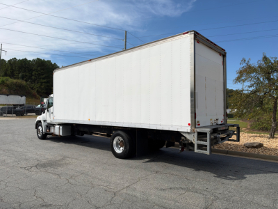 Box truck 2019 Hino 268A side/rear view showing large white box body and rear loading ramp.
