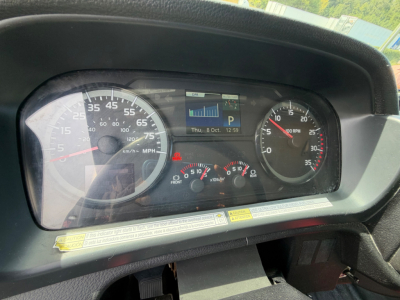 Dashboard of a 2019 Hino 268A showing speedometer, tachometer, and multifunction display with warning icons and gauges.