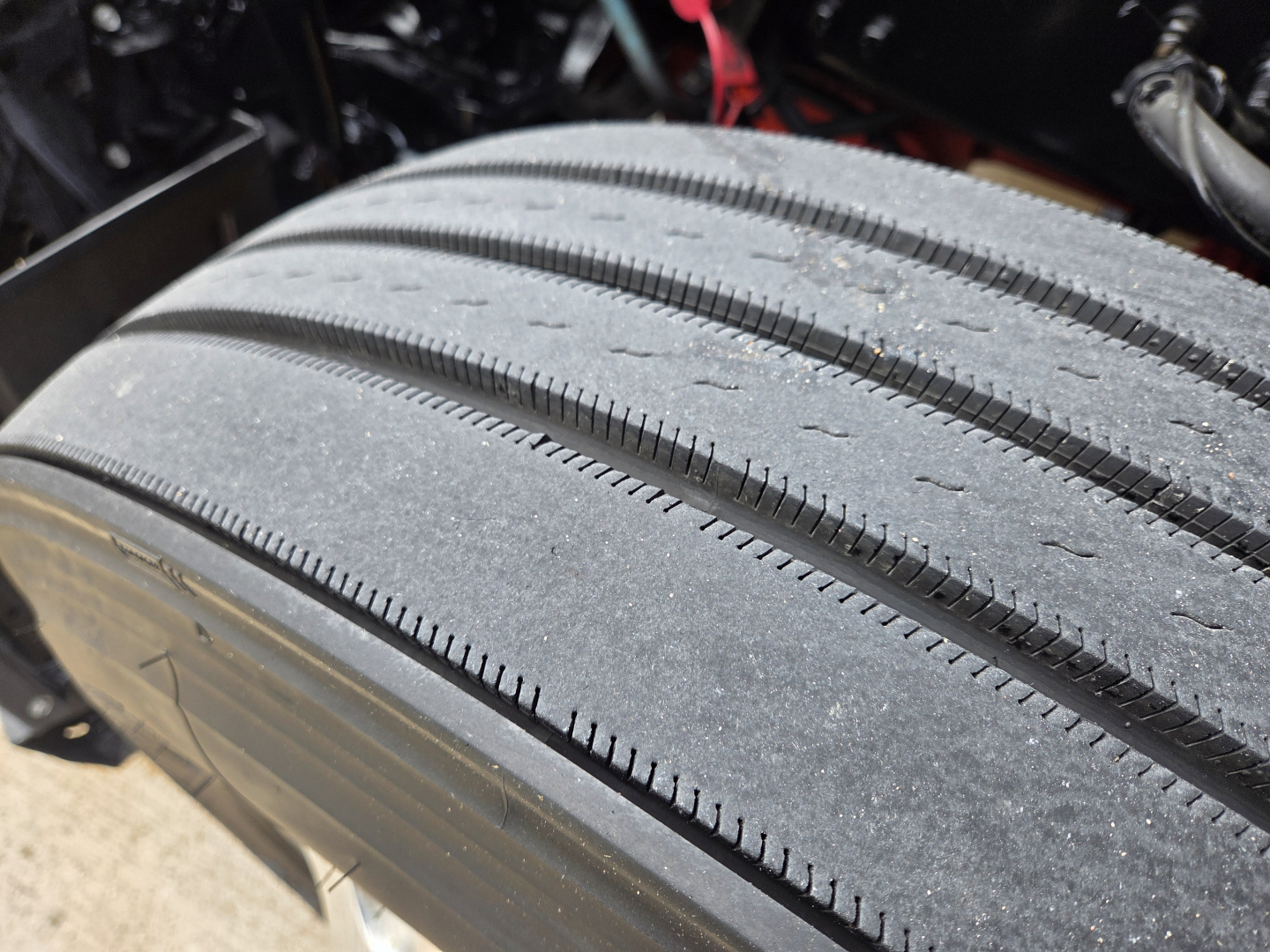 Kenworth truck wheel/tire close-up showing tread pattern and sidewall detail.