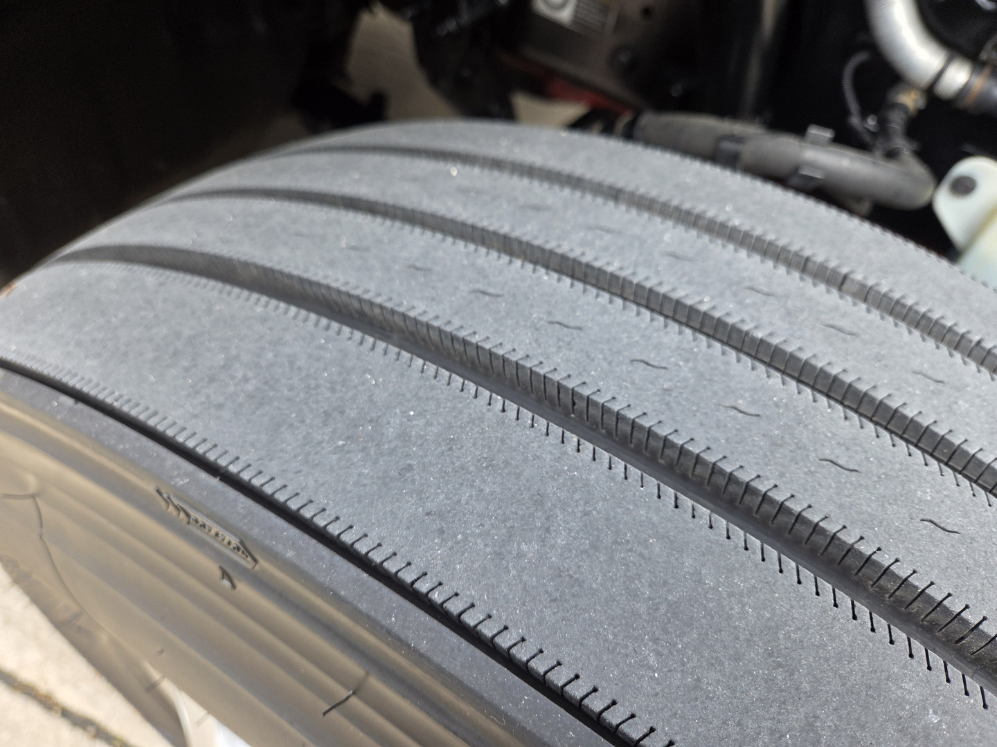 Truck tire close-up showing tread and sidewall with minimal dirt.