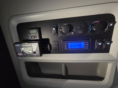 Kenworth T680 dash with climate controls and digital display, steering column area, small card reader slot