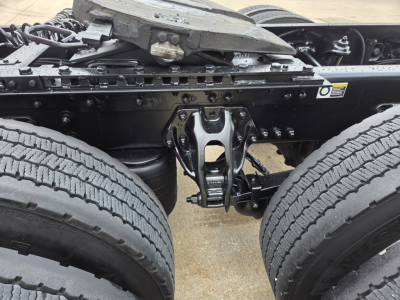 Kenworth truck rear undercarriage showing dual rear axles and suspension components in a close-up view.
