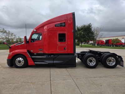Kenworth T680 semi-truck side profile in red cab with sleeper, black lower panels, and dual rear axle showing aftermarket wheels.