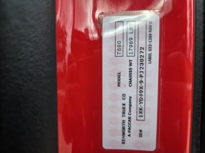 Kenworth T680 truck badge label showing model  T680 and VIN sticker on red exterior.
