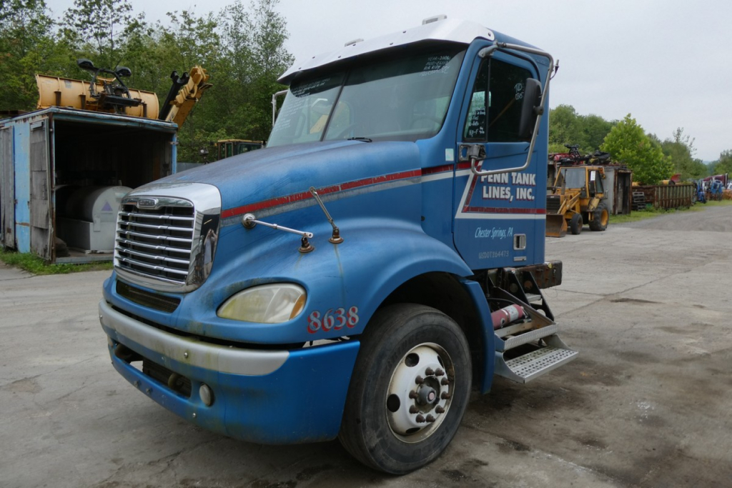 Truck cab showing Freightliner CL112 daycab with blue paint, front grille, and side steps. Visible text includes FENN TANK LINES INC on door and numbers 8638 on fender.