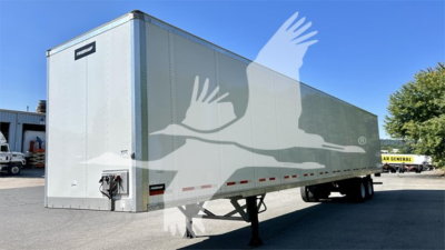 Fruehauf plate van trailer in side-front view showing aluminum exterior with trailer hitch and support legs visible.