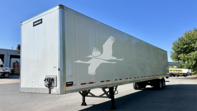 Fruehauf van trailer in a parking lot showing side logo and front area with hitch and support legs.