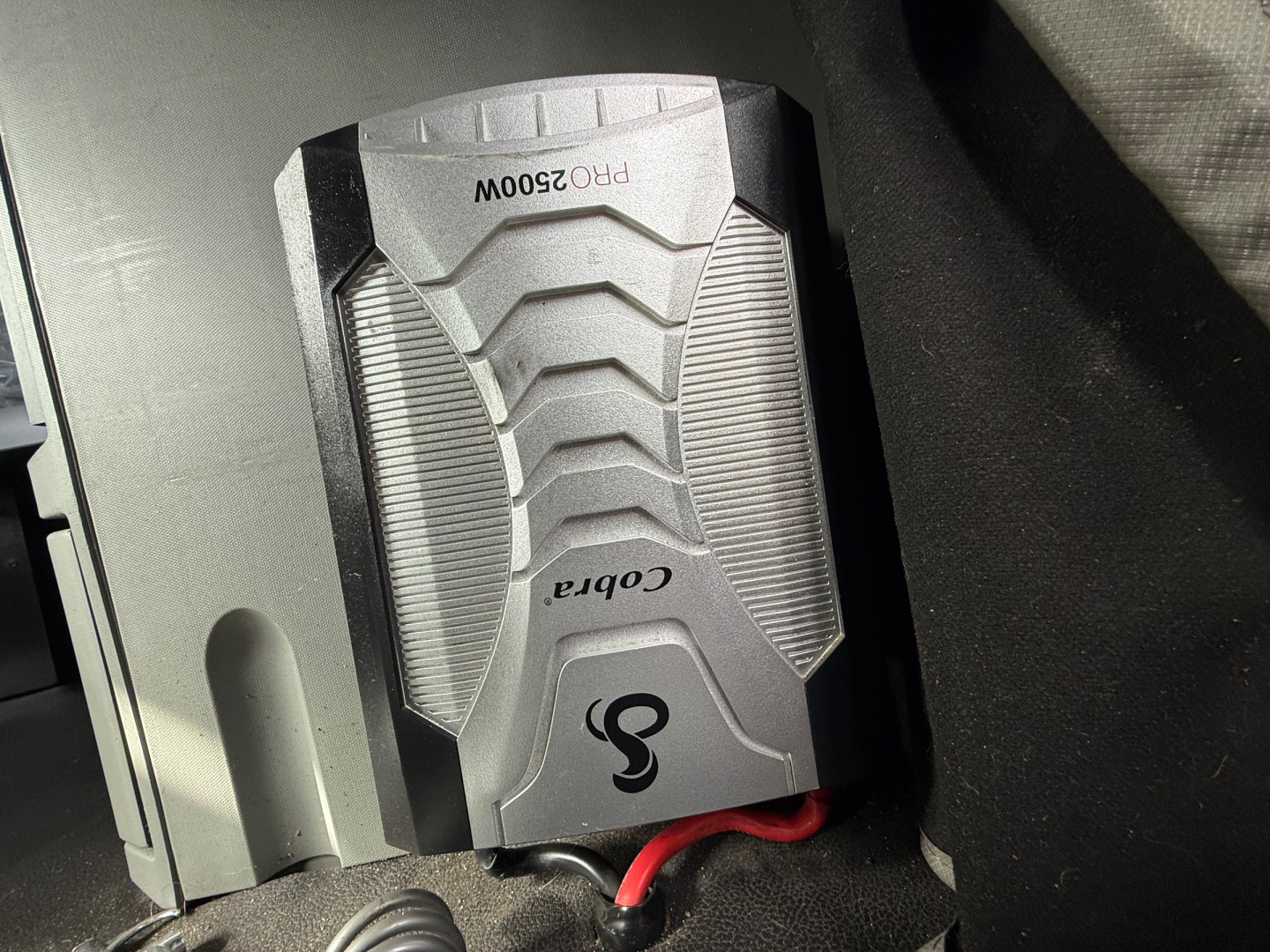 Kenworth T680 interior view showing a portable power inverter with labels PR02500W and Cobra logos.