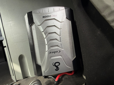 Kenworth T680 interior view showing a portable power inverter with labels PR02500W and Cobra logos.