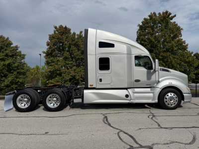 Kenworth T680 truck side view, no trailer attached, with sleeper cab and three rear axles visible.