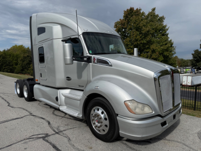 Kenworth T680 tractor-trailer in silver, front and side view showing sleeper cab and dual rear axles.