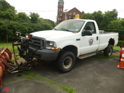 Ford F-350 Super Duty XL pickup with plow, white, side view showing front mount plow and service logo on door.