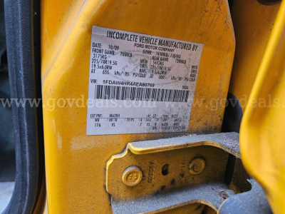 Label on a Ford dump truck showing incomplete vehicle manufactured by Ford Motor Company with VIN 1FDAW4HR4AEA80769, front GAWR weights, gross vehicle weight, and tire information.