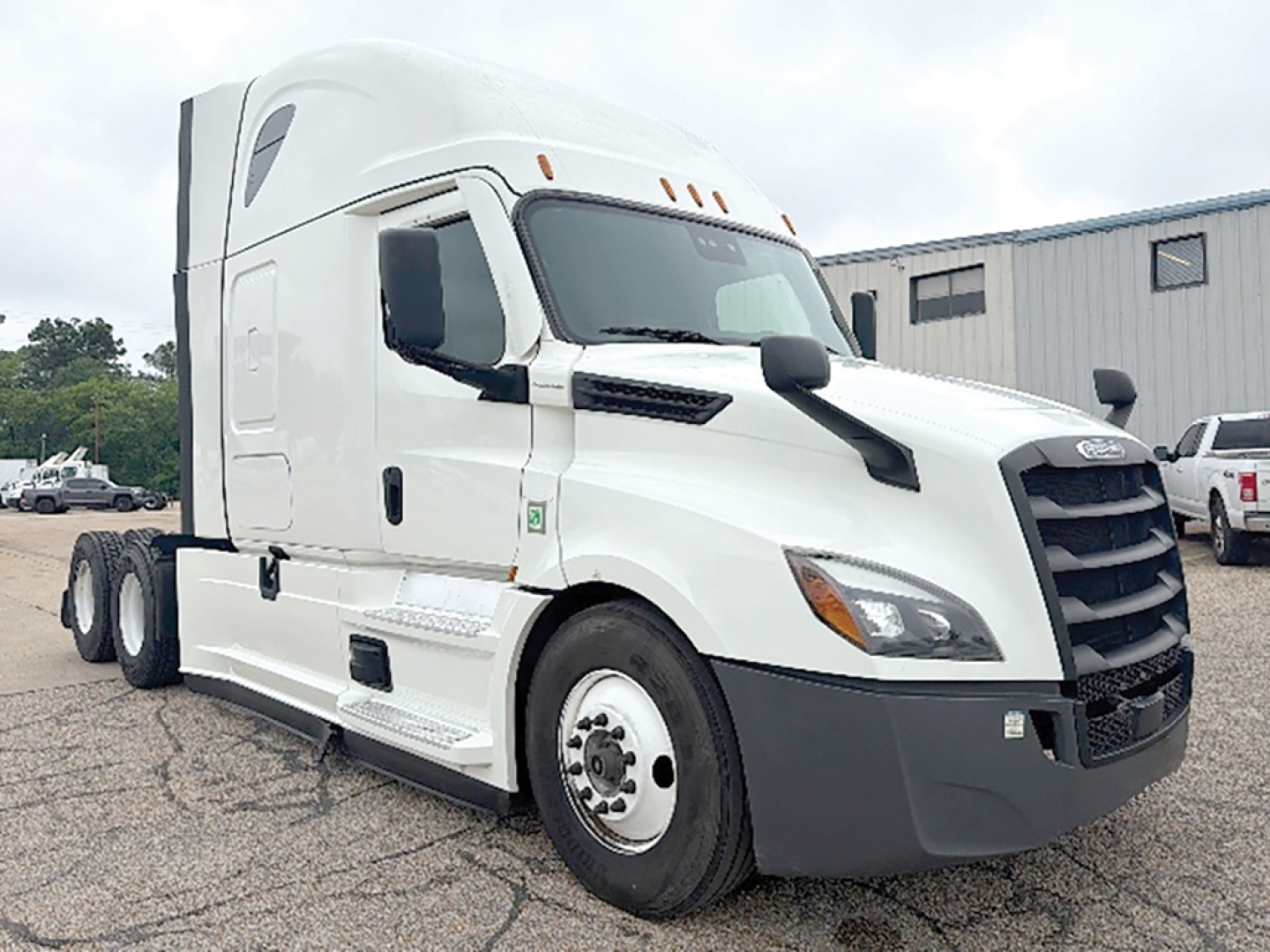 Freightliner Cascadia126 tractor-trailer cab showing front grille, windshield, and side mirrors. No visible text on the exterior components.