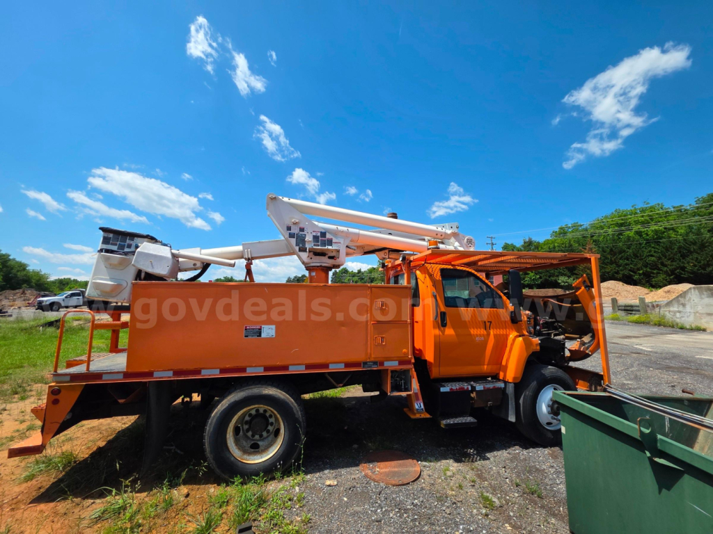 Altec TA45M bucket truck mounted on a brown/orange chassis with elevated boom in service bed showing controls and stowed bucket.
