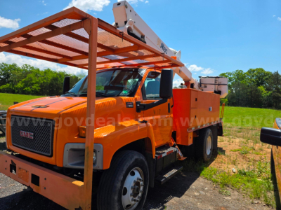 Orange 2003 Altec TA45M bucket truck with utility body and boom, front grille GMC, in an outdoor lot.