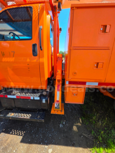 Altec TA45M bucket truck side view showing orange cab and equipment with stairs and storage box.