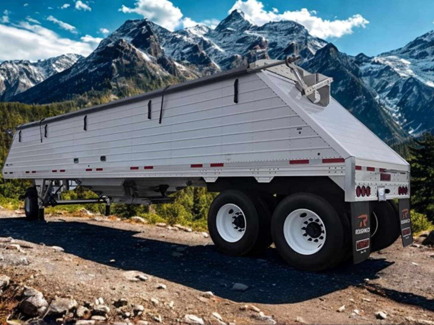 Trailer side view showing a white Timpte Super Hopper dump trailer with dual rear axles on uneven ground, mountainous backdrop.
