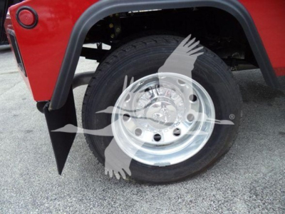 Ram 4500 wheel area showing chrome steel wheel with dual rear fender and tire, red body panel, black fender flare and winch category context.