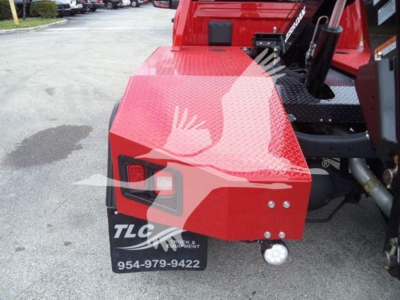 Ram 4500 winch truck rear showing red metal toolbox housing and TLC Equipment branding plate with phone number