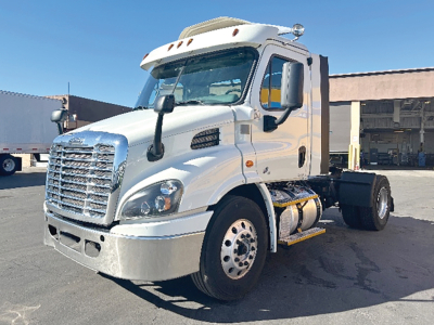 Truck chassis showing Freightliner Cascadia 113 cab and front section with chrome grille and headlamps.
