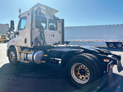 Truck chassis and cab of a Freightliner Cascadia113 showing the rear frame and wheels; no visible text readable on components.