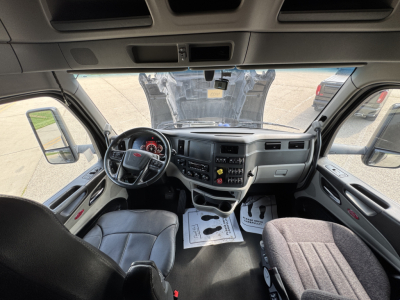 Peterbilt 579 truck interior cabin perspective showing steering wheel, dashboard, and seating view.