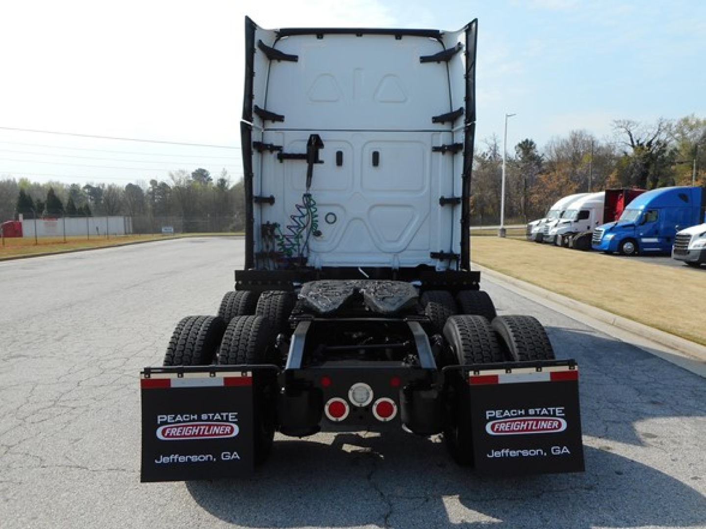 Rear view of a used 2024 Freightliner Cascadia 126 truck tractor with dual rear axles and back of cab visible.