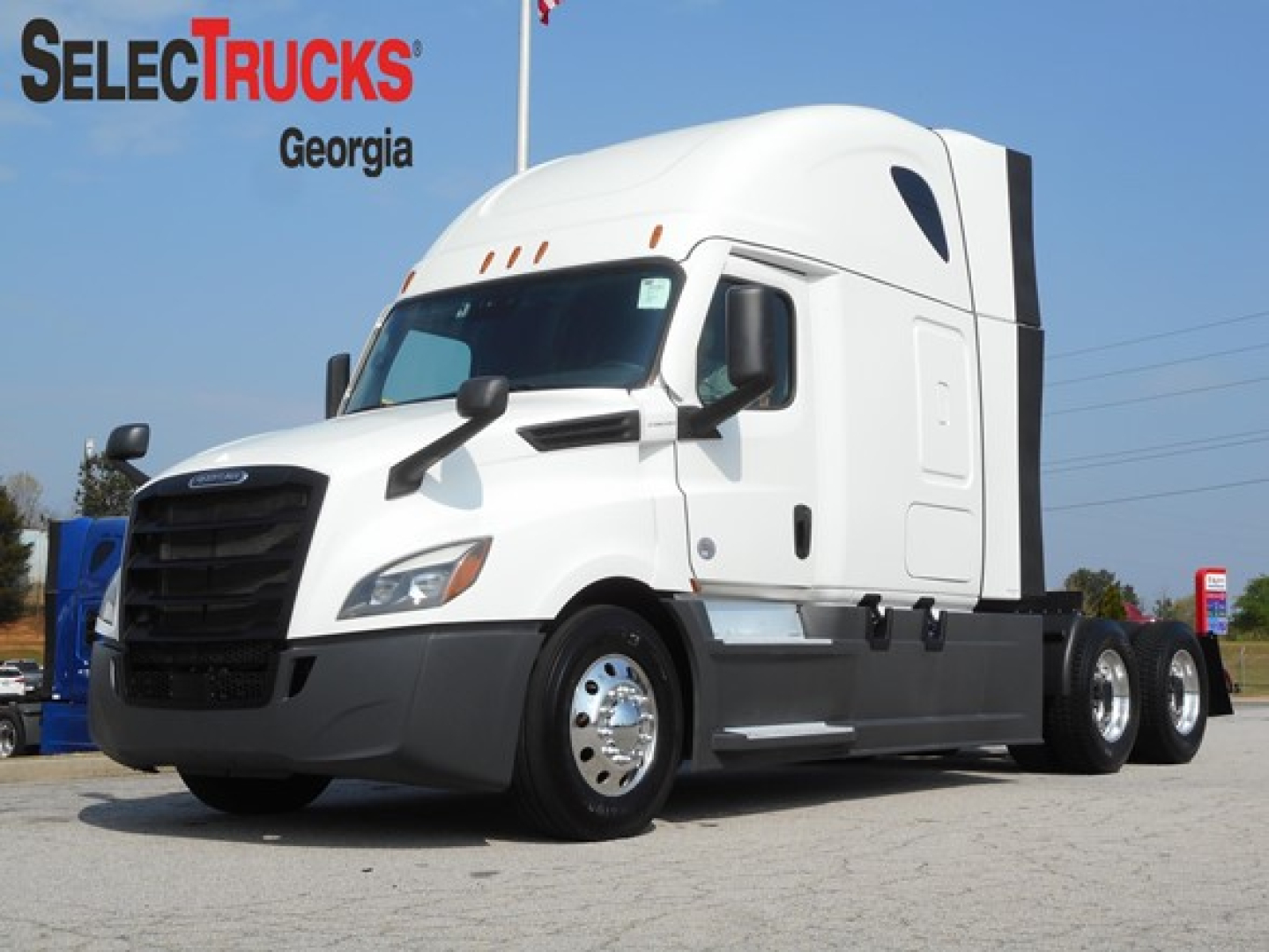 Truck in profile view showing a white 2024 Freightliner Cascadia 126 with sleeper cab and black grille.