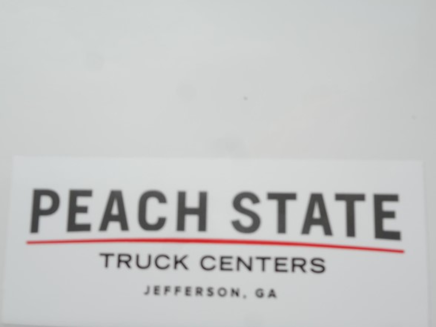Peach State Truck Centers sign with large PEACH STATE text and smaller TRUCK CENTERS JEFFERSON, GA