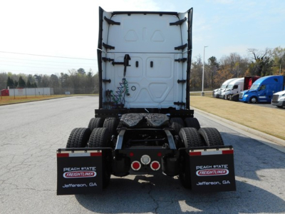 Rear view of a used 2024 Freightliner Cascadia 126 truck tractor with dual rear axles and back of cab visible.
