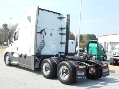 Truck chassis and cab rear view showing the Freightliner Cascadia 126 tractor with dual rear axles and fifth wheel, visible decal area and side mirrors.