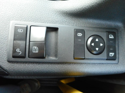 Dashboard switch panel with window controls and circular joystick on Freightliner Cascadia interior