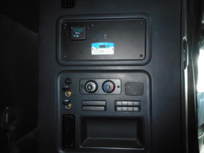 Panel with control switches and vents in Freightliner Cascadia sleeper cab showing a small switch panel and circular knobs.