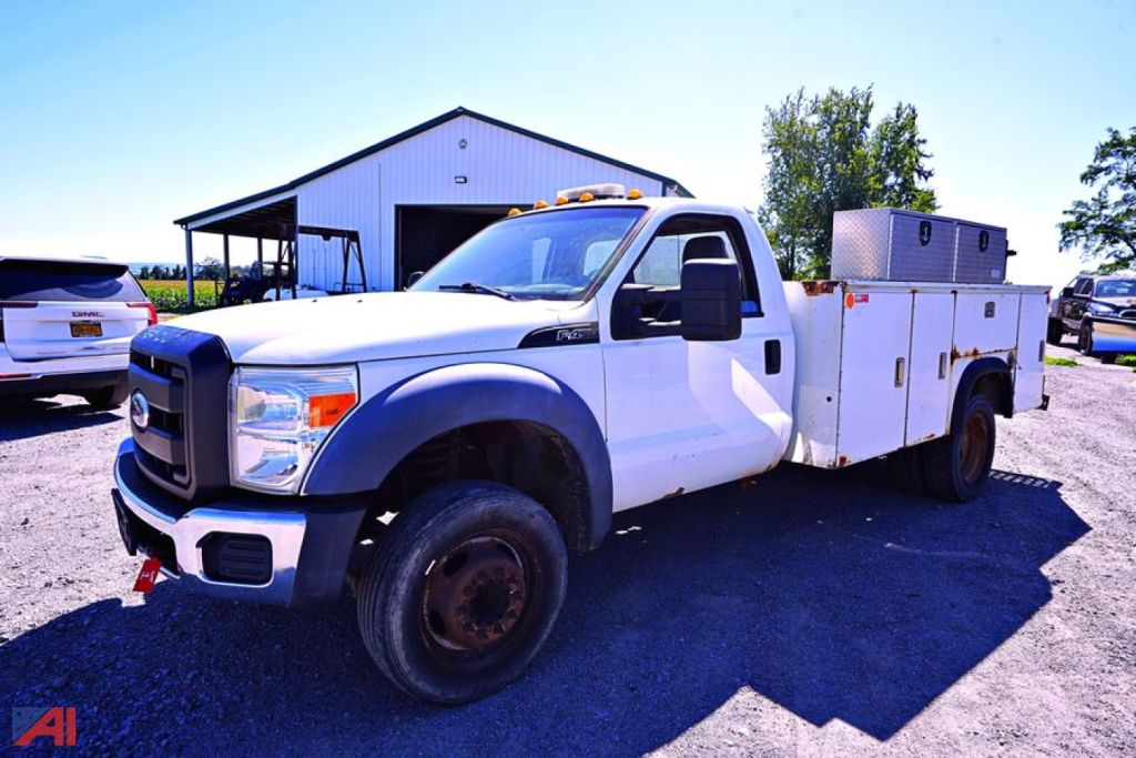 Ford F-450 SD XL Utility Truck in service use with utility body and storage boxes on rear, front view showing cab and cargo compartments.